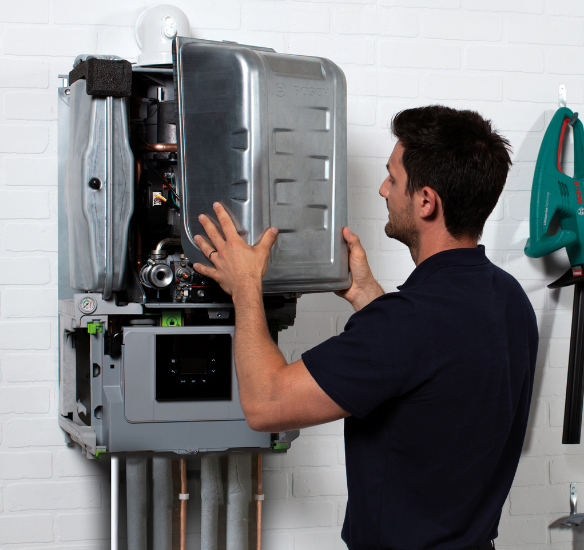 Installer checking boiler