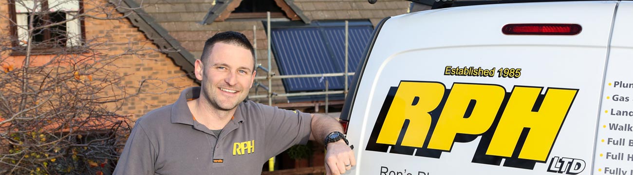 Photo of smiling RPH Installer standing next to his van.