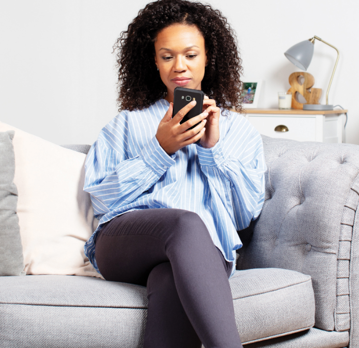 Woman looking at stoves on phone